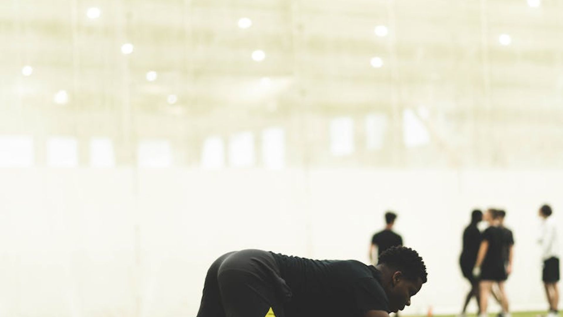 Man in a focused starting position for an exercise.